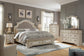 Realyn California King Upholstered Bed with Mirrored Dresser